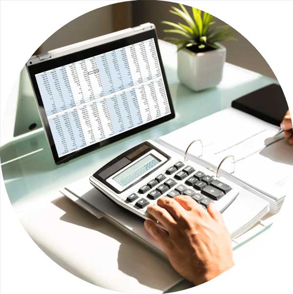 a person using a calculator and a laptop